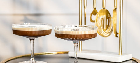 Art Deco crystal coupe cocktails styled with gold bar tools