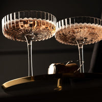Venus Seashell Coupetini Cocktail Glasses Set of 4 – two filled with pink sparkling wine beside a cork