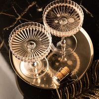 Venus Seashell Coupetini Cocktail Glasses Set of 4 – top view of two glasses on a gold tray with a cork