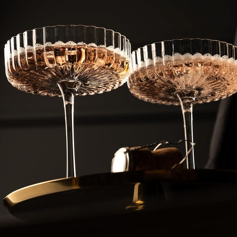 Venus Seashell Coupetini Cocktail Glasses Set of 4 – two filled with pink sparkling wine beside a cork