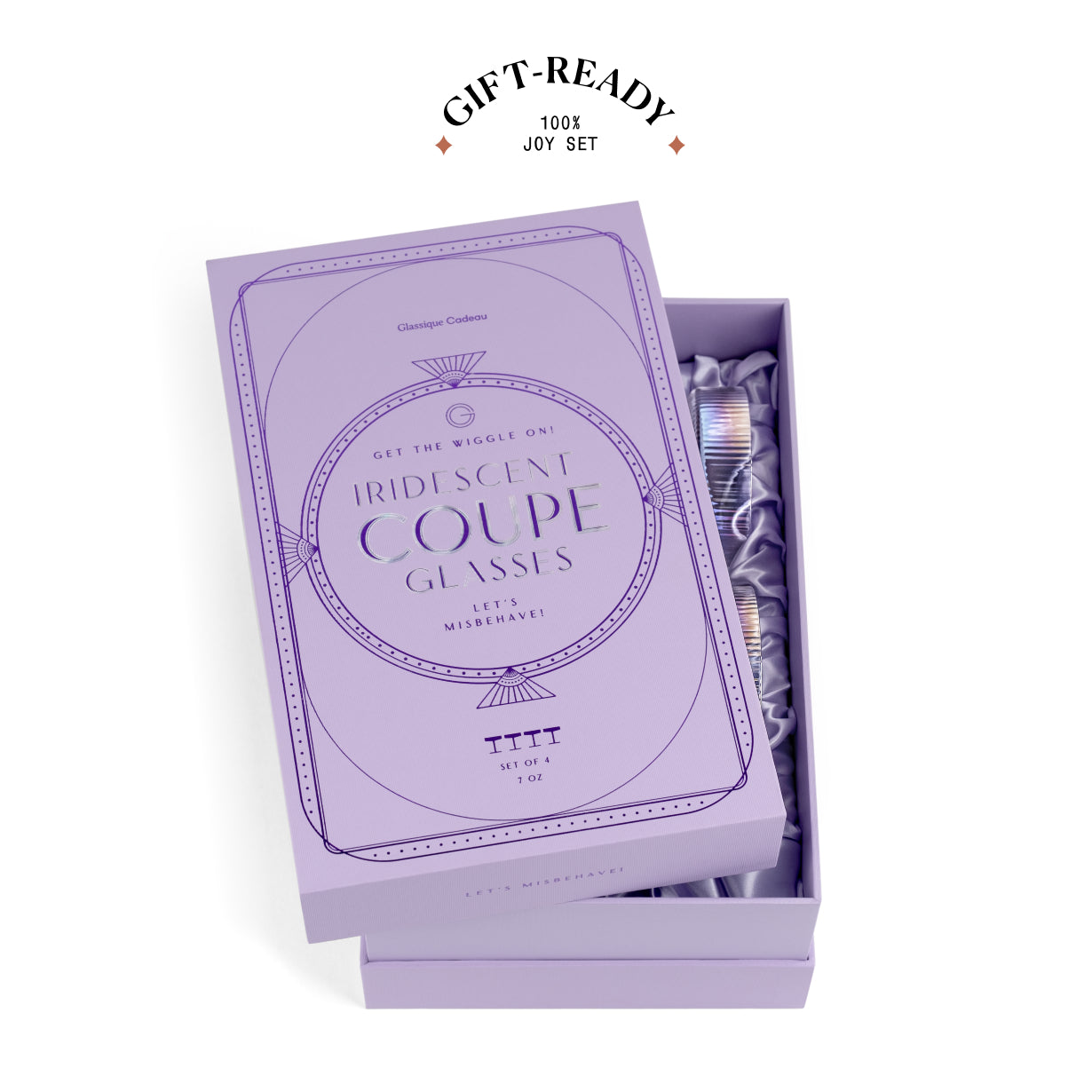 A lavender gift box set for George Clooney Iridescent Coupe Glasses, shown open with the box lid leaning on top and revealing packaged iridescent glasses inside. A 'GIFT-READY 100% JOY SET' badge is printed above the box on a clean white background.